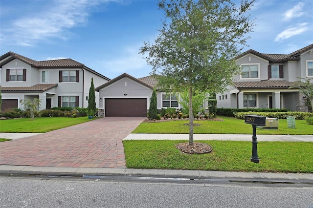 view of front of property featuring a garage and a front yard