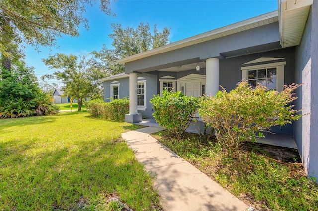 doorway to property featuring a yard