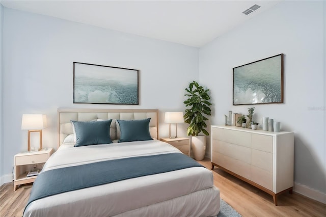 bedroom featuring light wood-style floors, baseboards, and visible vents