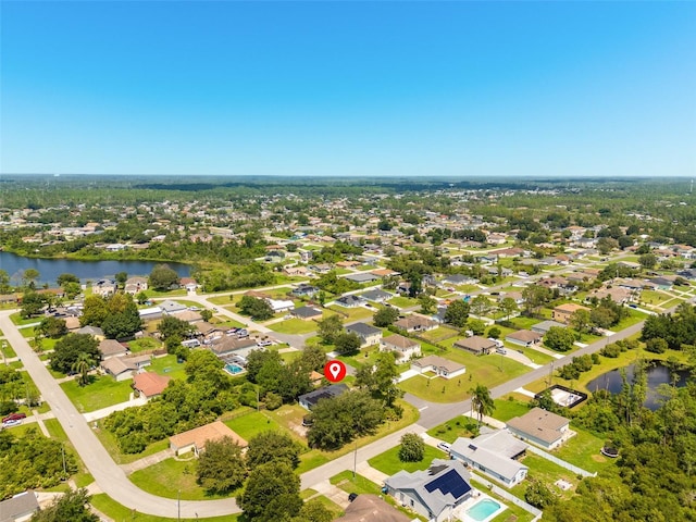 birds eye view of property featuring a water view and a residential view