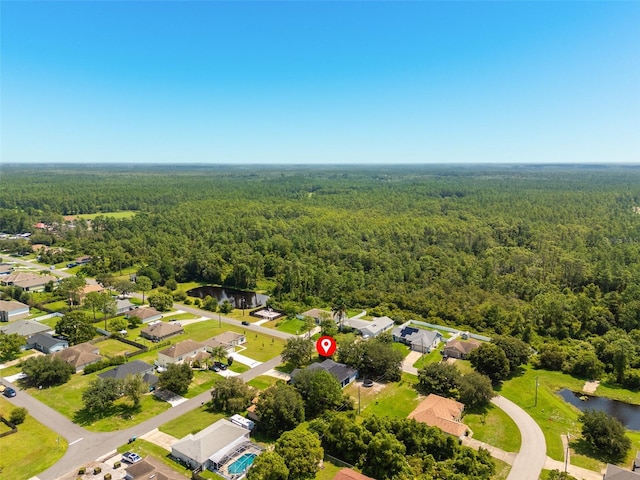 aerial view with a water view, a forest view, and a residential view