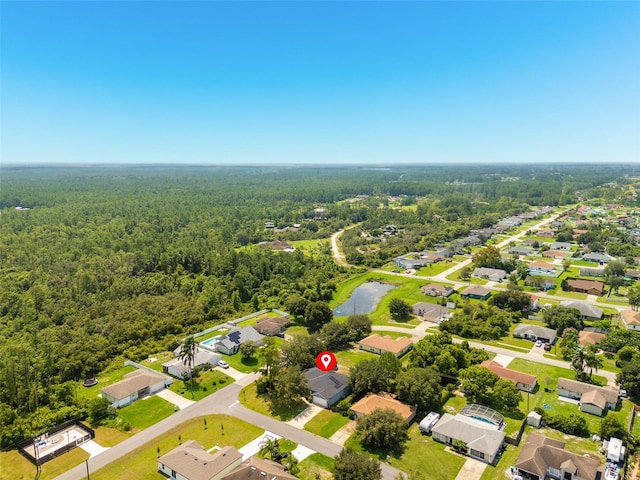 birds eye view of property with a forest view and a residential view