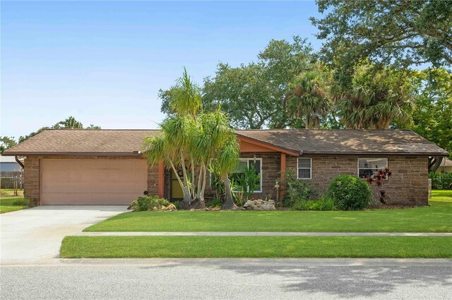 ranch-style home with a garage and a front yard