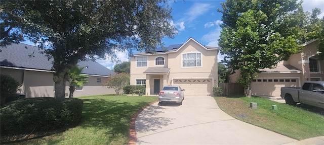 view of front property featuring a garage and a front yard