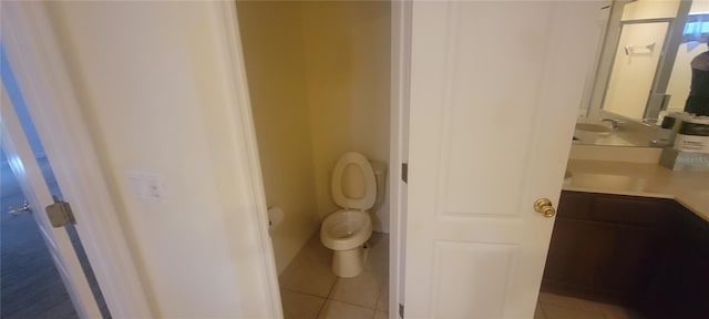 bathroom featuring tile patterned flooring, toilet, and vanity