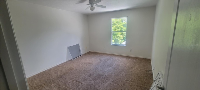 spare room with ceiling fan and carpet