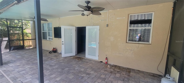 view of patio / terrace with ceiling fan and a lanai