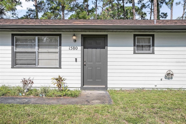 property entrance with a yard