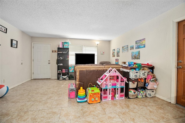 playroom with a textured ceiling and tile patterned flooring