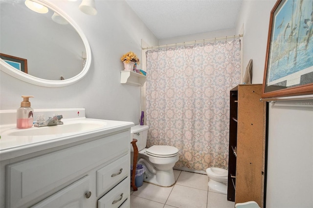 bathroom with toilet, vanity, tile patterned floors, curtained shower, and a textured ceiling