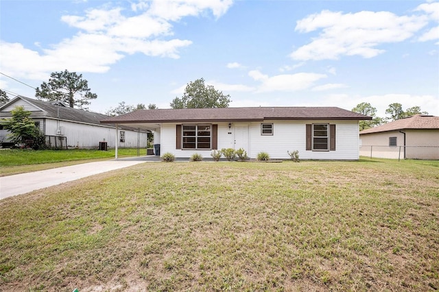 ranch-style house featuring a carport and a front lawn