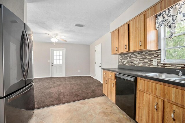 kitchen featuring decorative backsplash, black dishwasher, stainless steel fridge, ceiling fan, and light tile patterned flooring