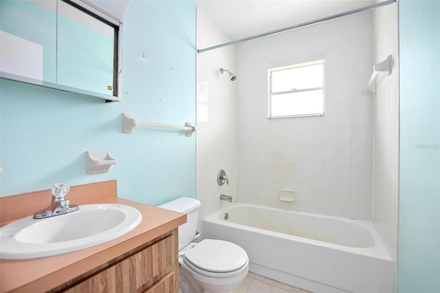 full bathroom featuring toilet, tiled shower / bath, vanity, and tile patterned floors