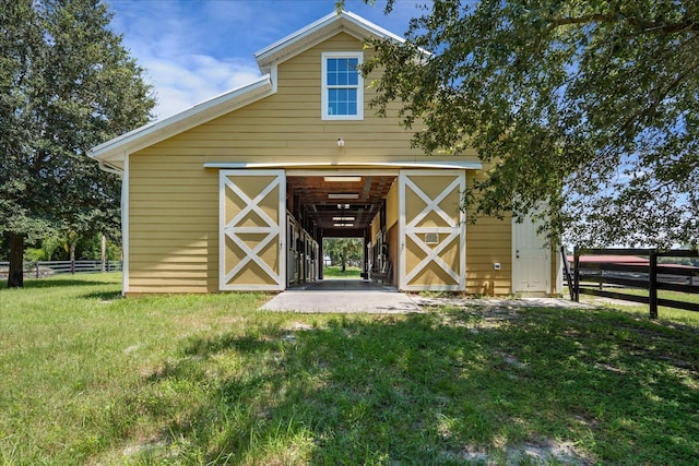 view of outbuilding with a lawn