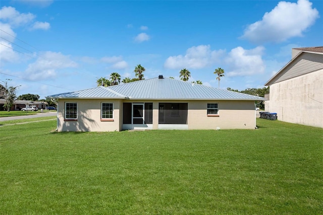 rear view of property with a yard