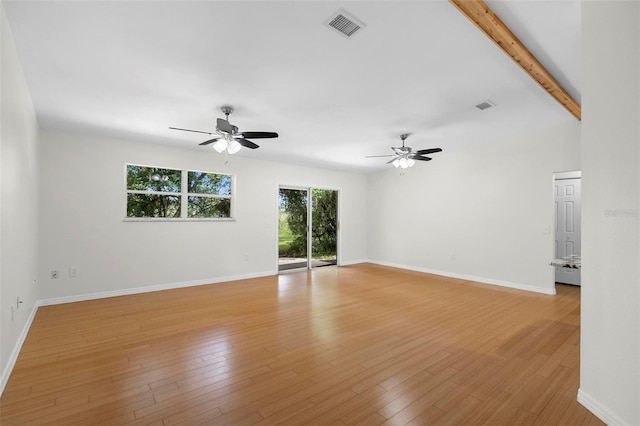 unfurnished room featuring ceiling fan, vaulted ceiling with beams, and light hardwood / wood-style floors