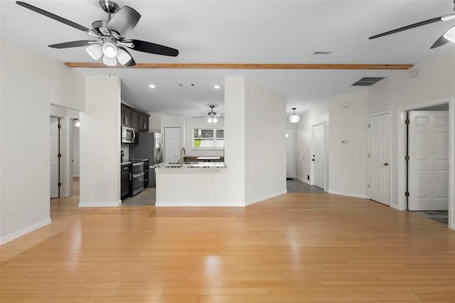 unfurnished living room featuring ceiling fan, light hardwood / wood-style flooring, and sink