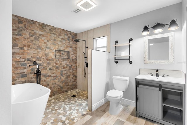 full bathroom featuring hardwood / wood-style floors, vanity, toilet, and shower with separate bathtub