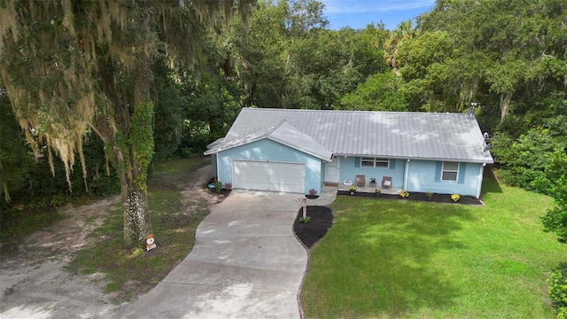 single story home featuring a garage and a front yard