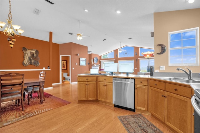 kitchen featuring pendant lighting, sink, appliances with stainless steel finishes, light wood-type flooring, and vaulted ceiling