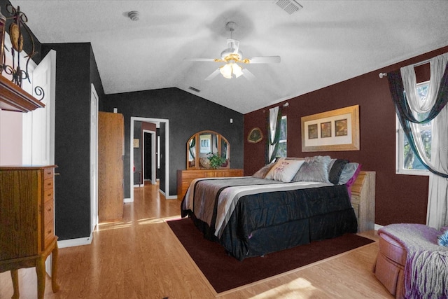 bedroom with light wood-type flooring, lofted ceiling, and ceiling fan