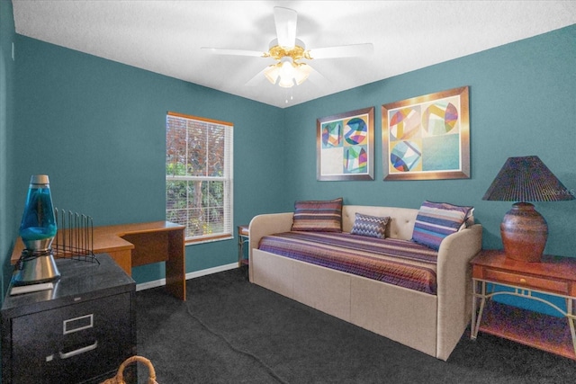 bedroom with ceiling fan and dark carpet