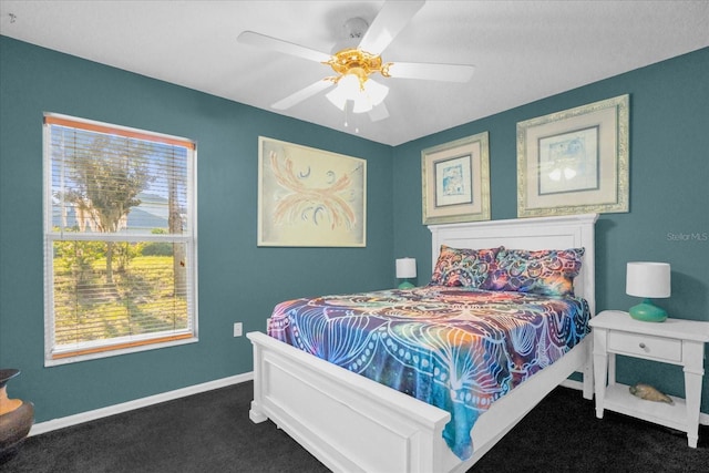 bedroom with dark colored carpet and ceiling fan