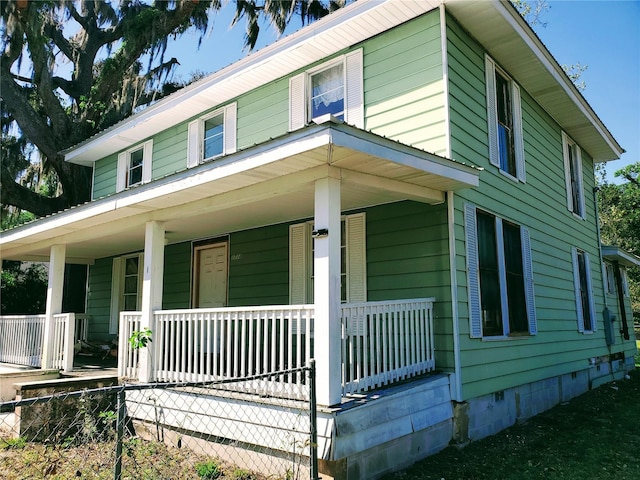1714 President St, Palatka, FL 32177 - view of front of property with fence, crawl space, and a porch