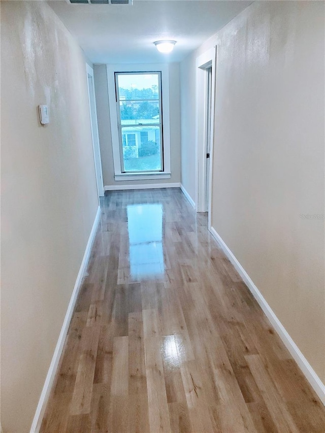 hallway with light wood-type flooring