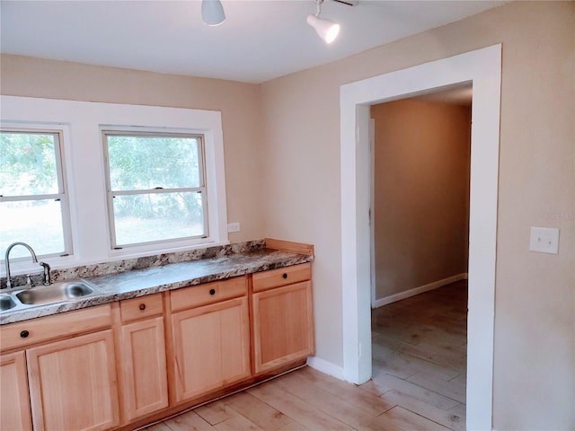 kitchen featuring sink, light brown cabinetry, and light hardwood / wood-style floors