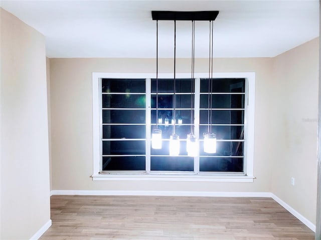 unfurnished dining area featuring hardwood / wood-style floors