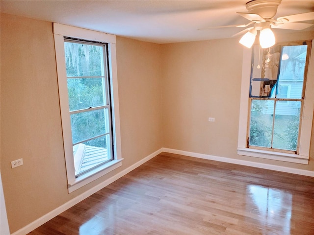 unfurnished room featuring light hardwood / wood-style floors, ceiling fan, and a healthy amount of sunlight