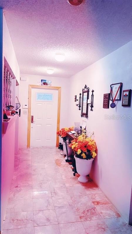 hallway with a textured ceiling