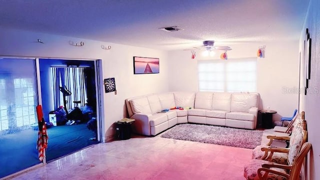 living room with ceiling fan and carpet flooring