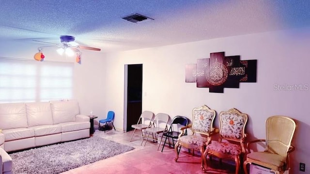 carpeted living room featuring a textured ceiling and ceiling fan