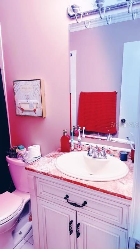 bathroom featuring vanity, toilet, and tile patterned floors