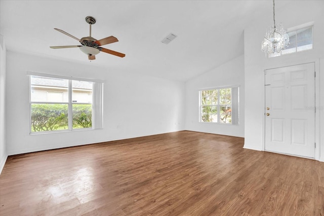 foyer with ceiling fan with notable chandelier, high vaulted ceiling, and hardwood / wood-style floors