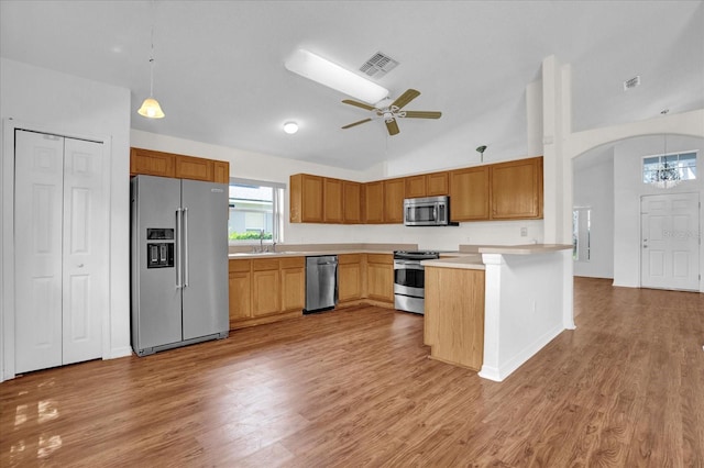 kitchen featuring light hardwood / wood-style flooring, sink, decorative light fixtures, ceiling fan, and stainless steel appliances