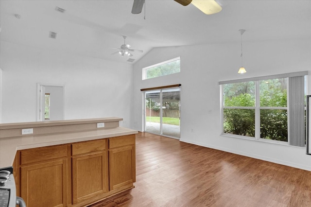 kitchen featuring vaulted ceiling, dark hardwood / wood-style floors, ceiling fan, and pendant lighting