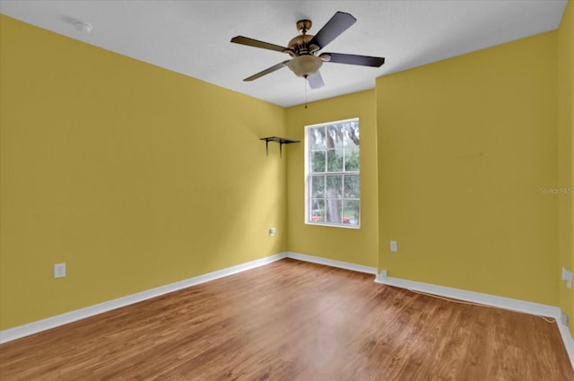 unfurnished room featuring hardwood / wood-style floors and ceiling fan