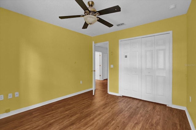 unfurnished bedroom with hardwood / wood-style flooring, ceiling fan, and a closet