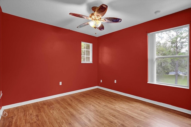 unfurnished room with hardwood / wood-style floors and ceiling fan