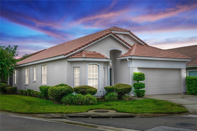 view of front facade with a lawn and a garage