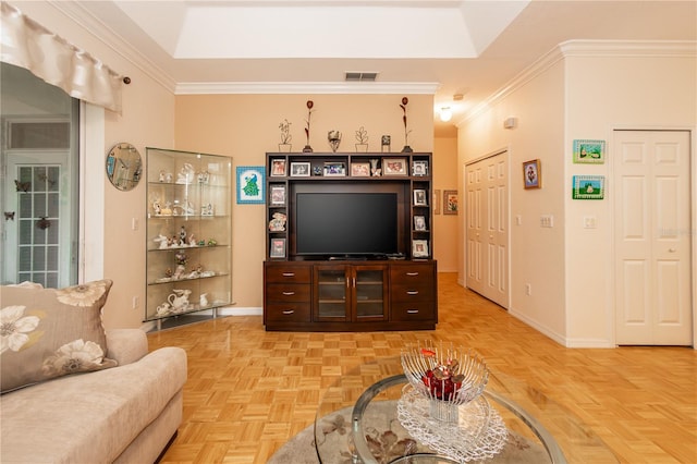 living room featuring a tray ceiling, crown molding, and light parquet floors