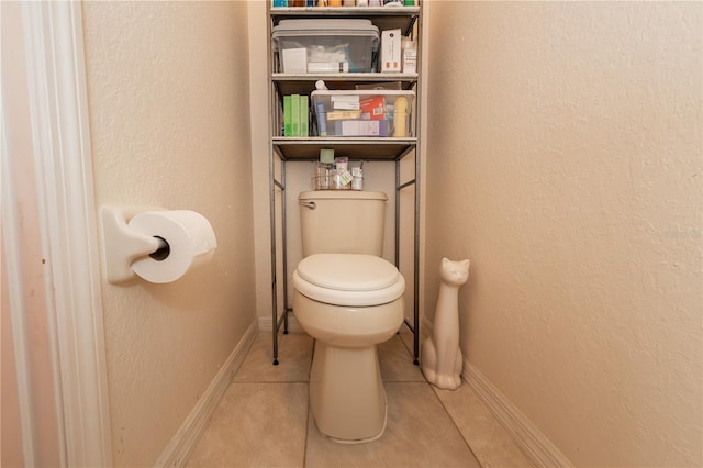 bathroom featuring tile patterned flooring and toilet