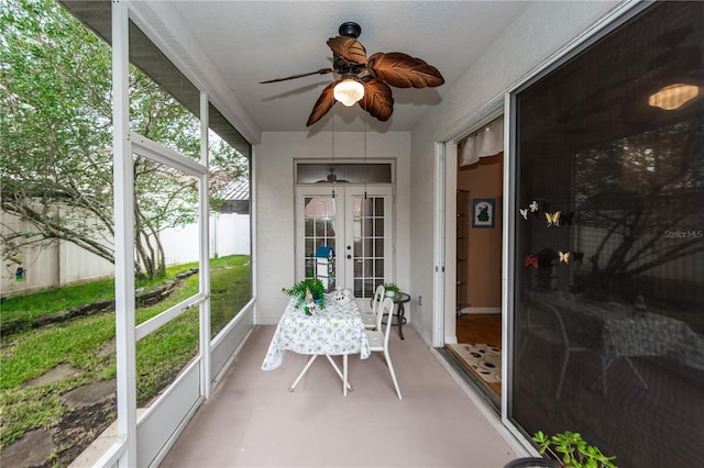 sunroom featuring ceiling fan and french doors