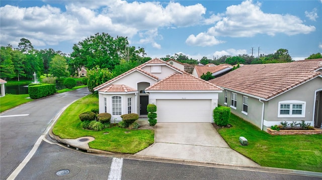 mediterranean / spanish-style home featuring a front yard and a garage