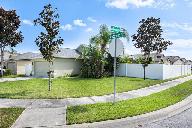 view of front of house with a garage and a front yard