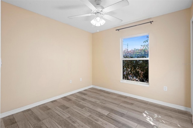 unfurnished room featuring ceiling fan, light wood-type flooring, and baseboards