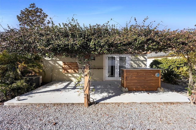 exterior space featuring stucco siding and a patio